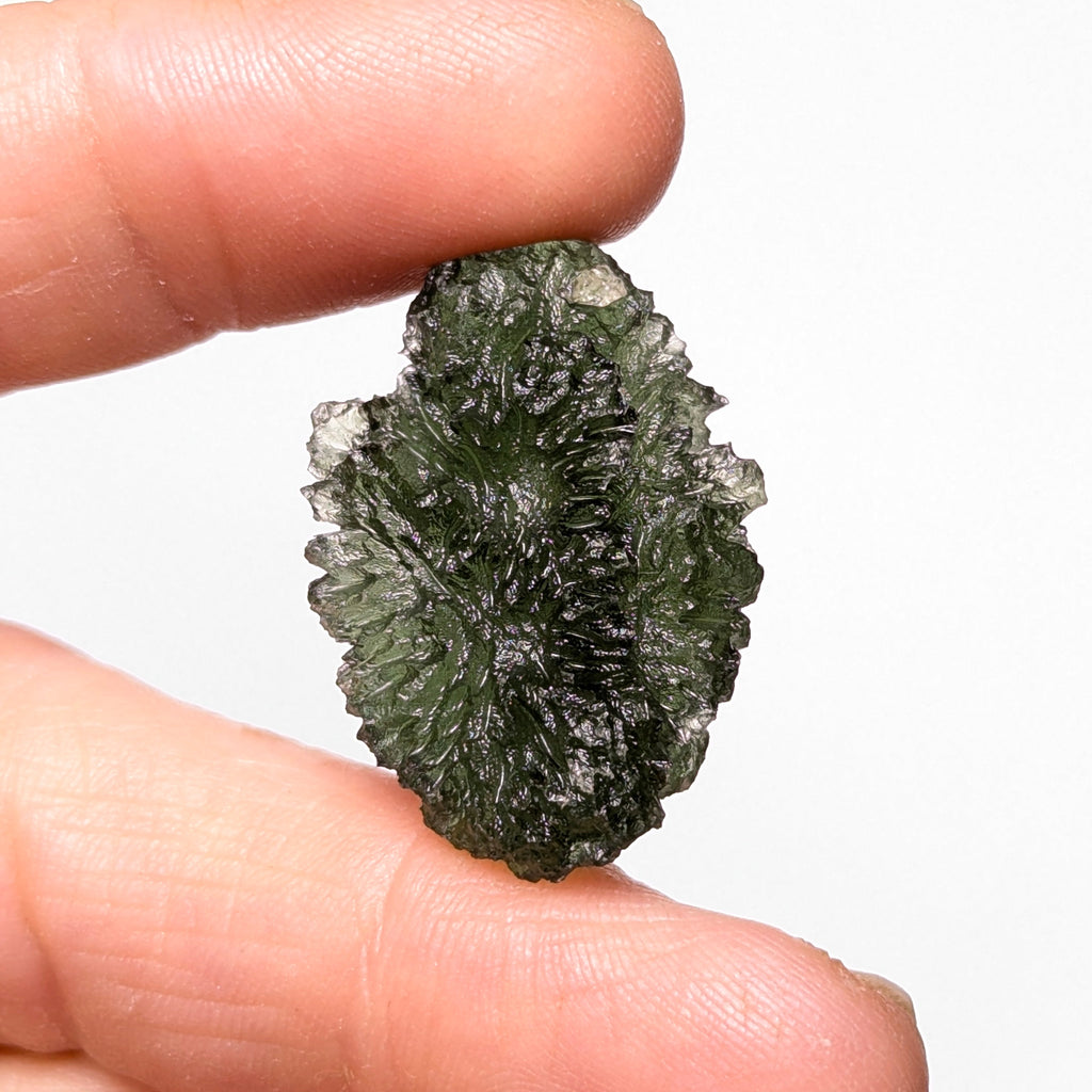 Natural Moldavite from the Olešnice locality weighing 5.67 g with egg-shaped form, deep sharply textured sculpture, rich green translucency and preserved natural surface - back side.