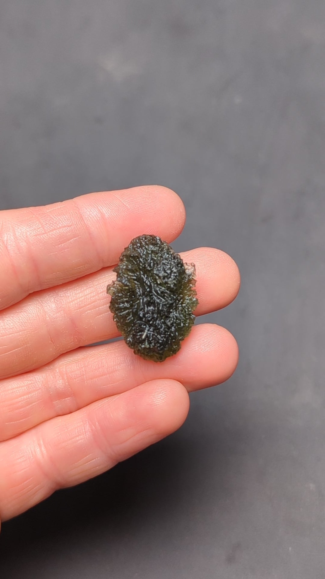 Natural Moldavite from the Olešnice locality weighing 5.67 g with egg-shaped form, deep sharply textured sculpture, rich green translucency and preserved natural surface - video.