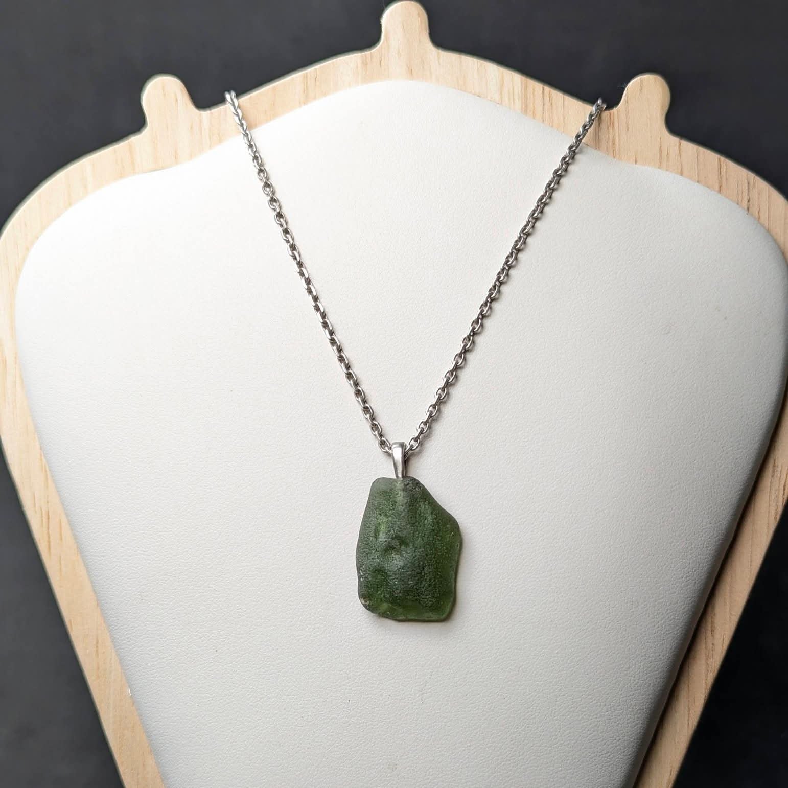 Natural Radomilice 4 g moldavite pendant with Ag 925 silver bail, light yellow-green color and naturally rounded sculpted surface - front side.