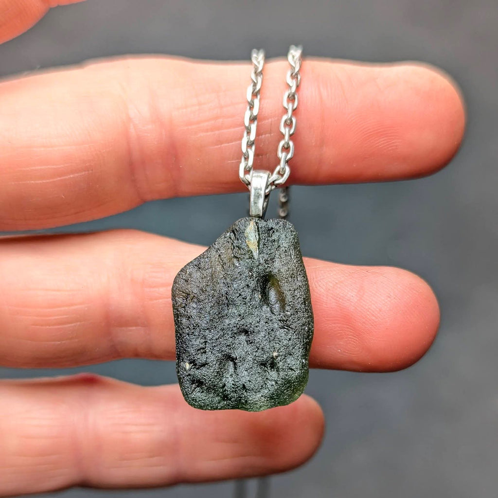 Natural Radomilice 4 g moldavite pendant with Ag 925 silver bail, light yellow-green color and naturally rounded sculpted surface - back side.