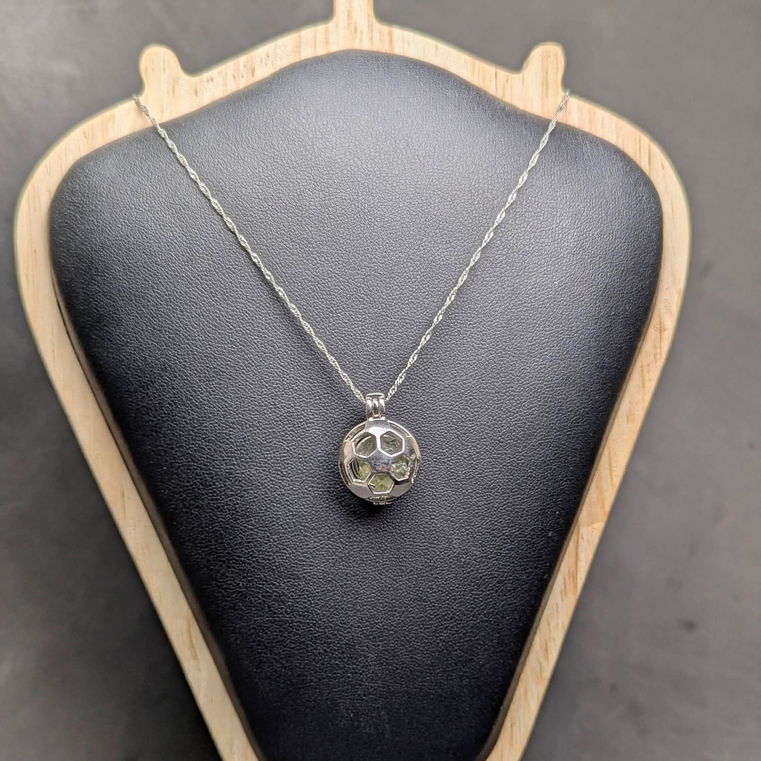 Ag 925 sterling silver necklace with natural light green Brusná 4.37 g moldavite in silver cage pendant  - front view, black background.