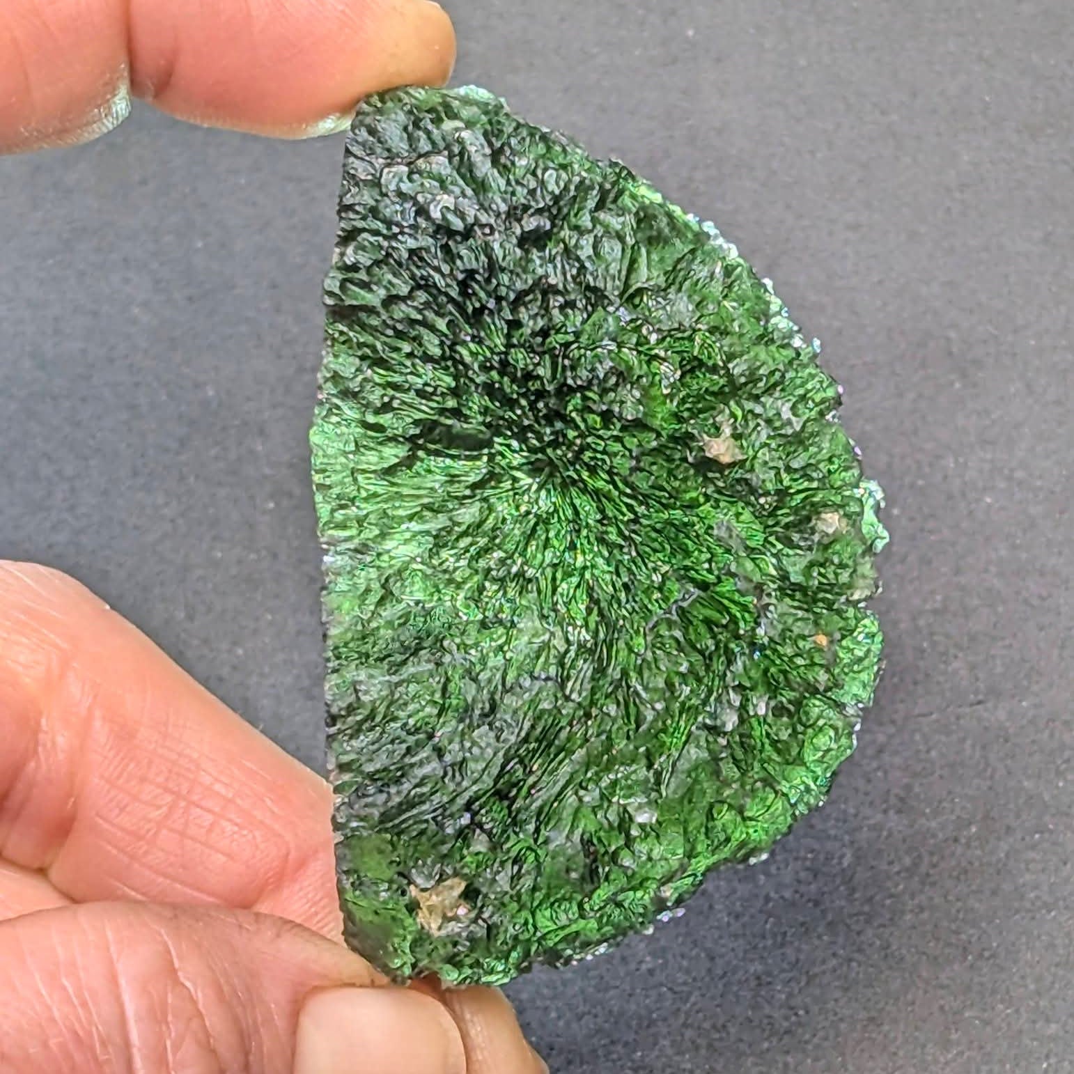 Natural moldavite from Krasejovka, 41 g half-disc - back side, backlight.