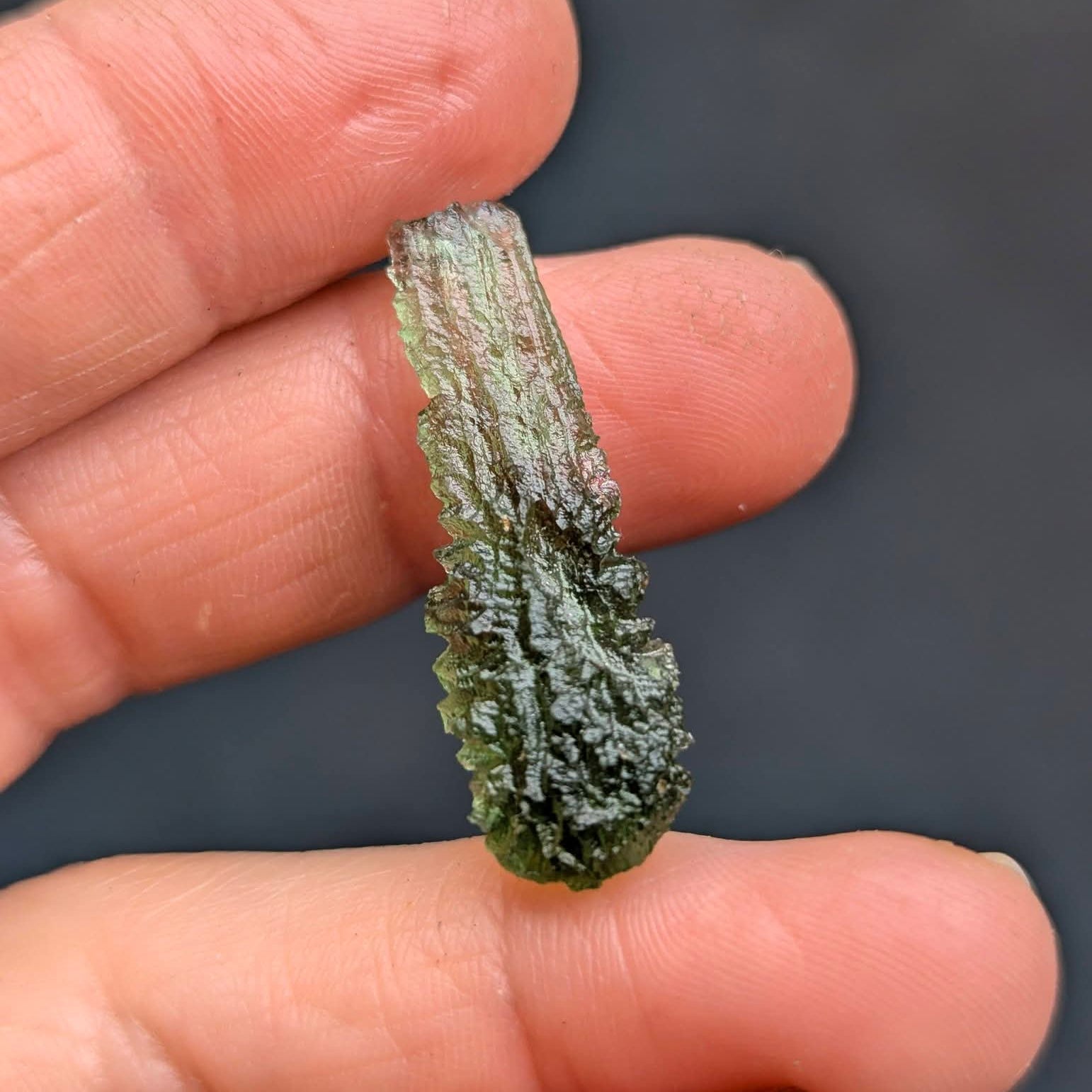 Moldavite Olešnice 1.73g - drop shape, smooth neon green translucent top, dense dark sculpture below - back side