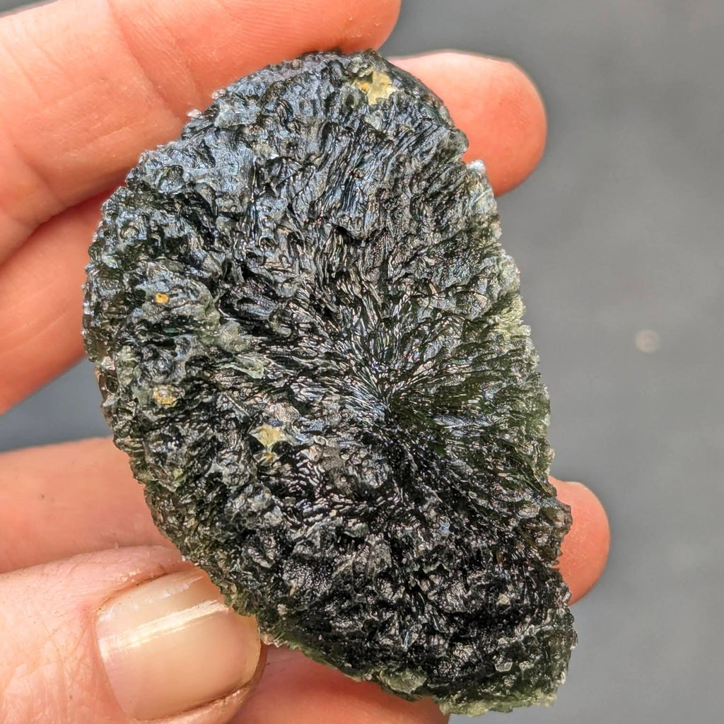 Natural moldavite from Krasejovka, 41 g half-disc - front view.